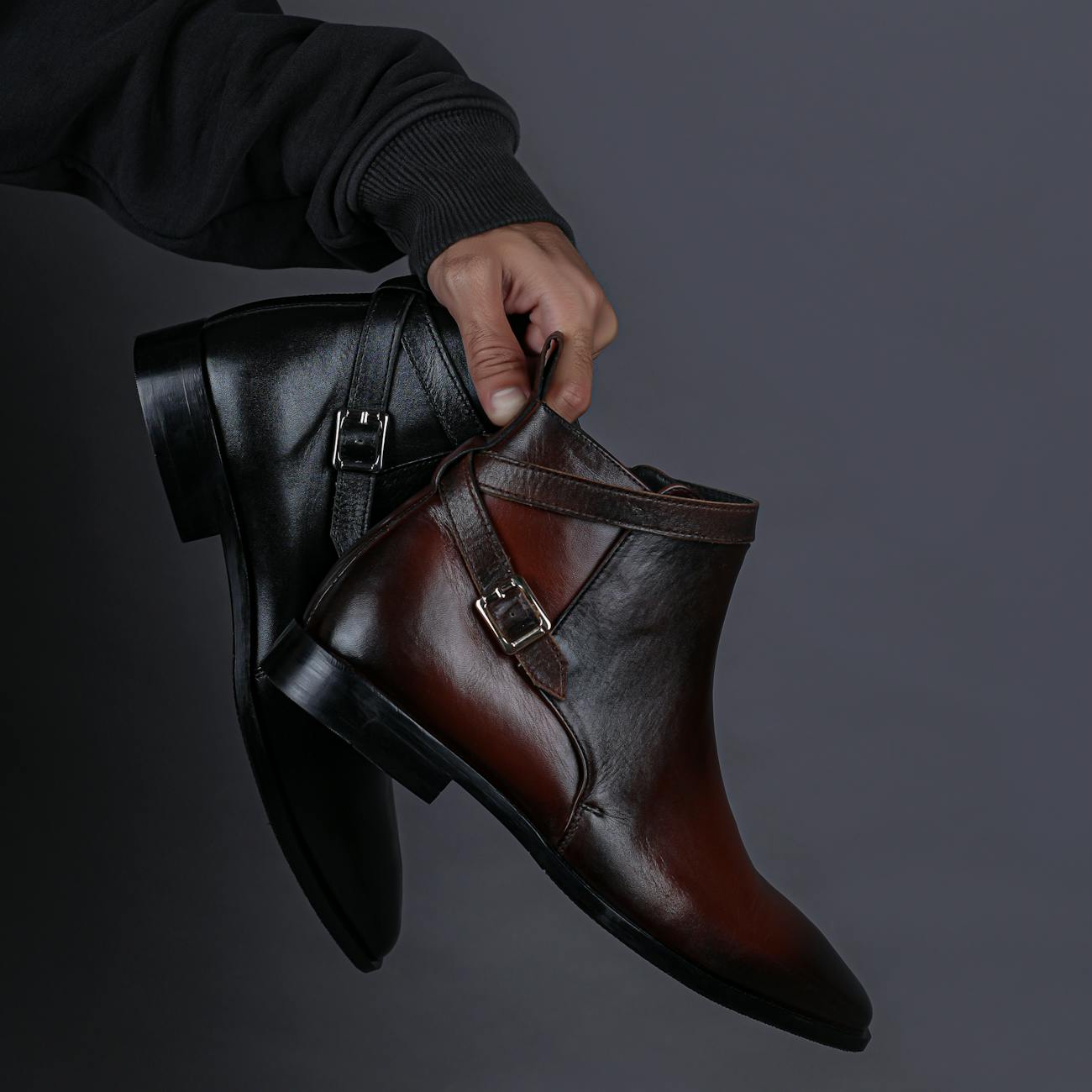 man hand holding shoes