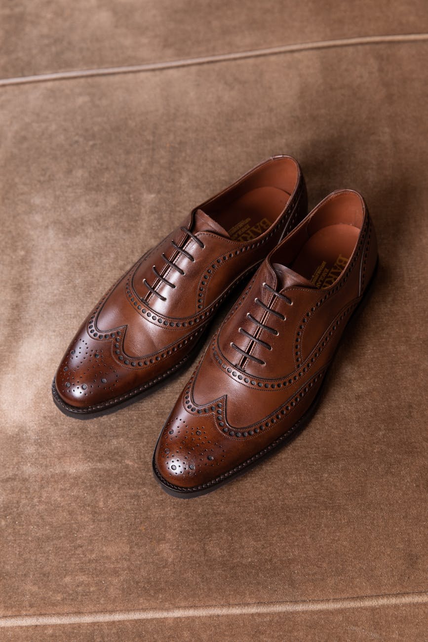 a close up shot of a pair of brogue shoes